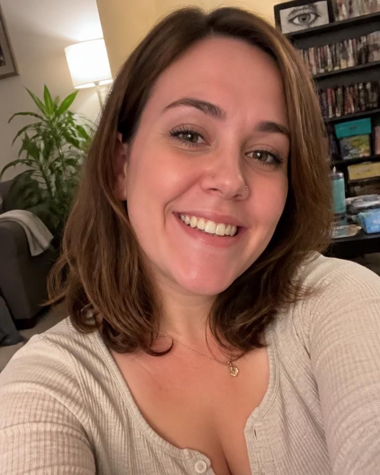 Casual selfie taken indoors with a cluttered background